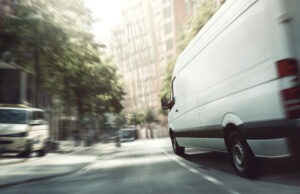 white lansing delivery truck speeds downtown