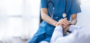 nurse holds hands of patient after UPS truck accident