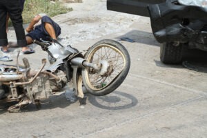 bent-up motorcycle on the road