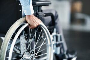 close-up on man’s hand on wheelchair